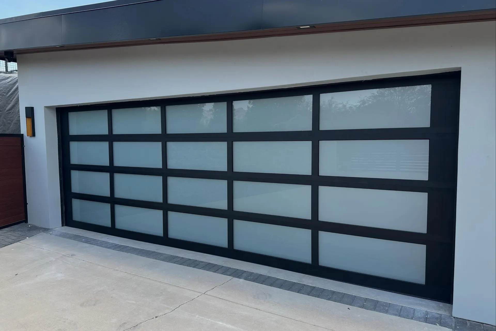 Full-view black aluminum and glass garage door