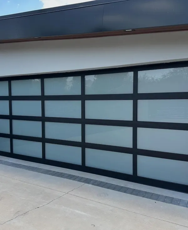 Black full-view aluminum garage door with frosted glass