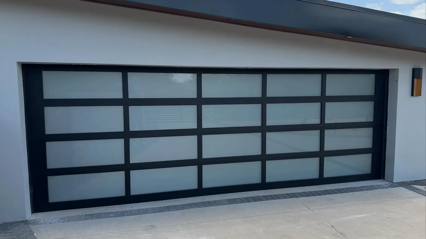 Black full-view aluminum garage door with frosted glass