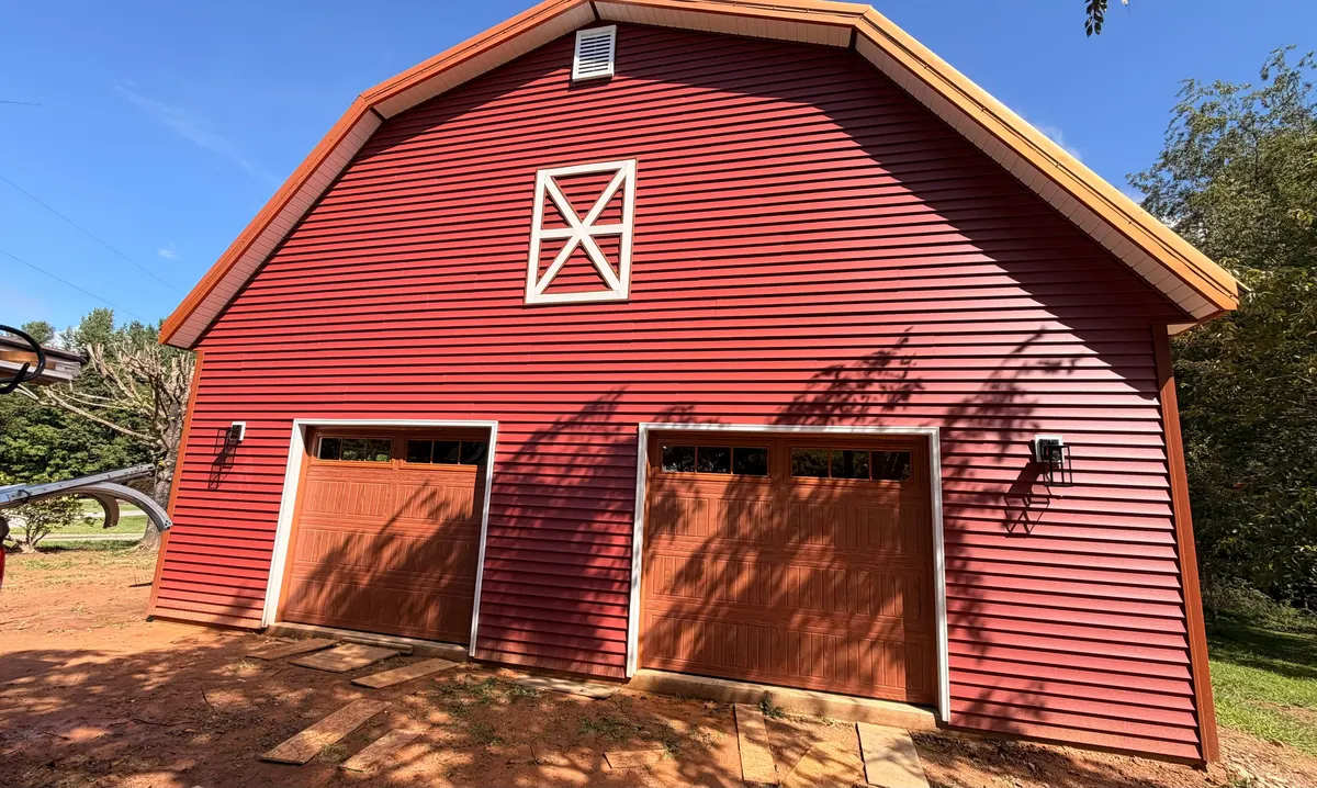 Red barn-style garage with two wood-look garage doors