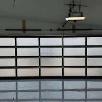 Opener above a full-view glass garage door