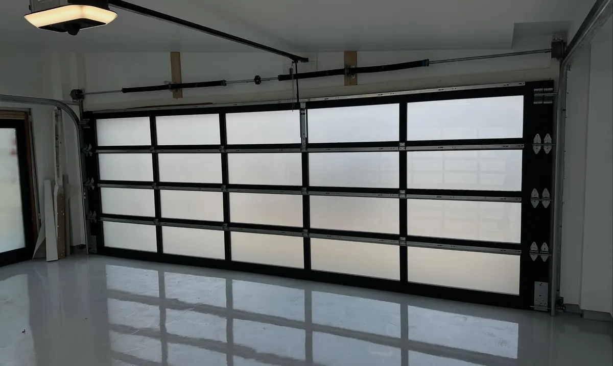 Full-view glass garage door and opener after a tune-up