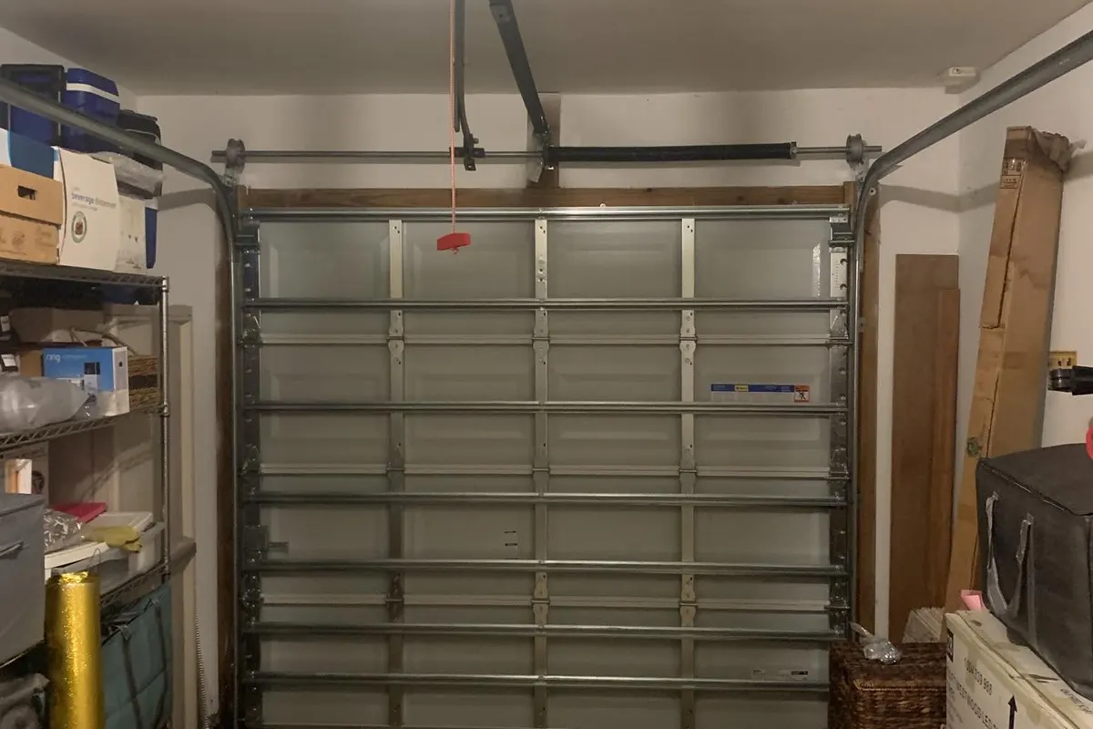 Garage door opener with light above an insulated door