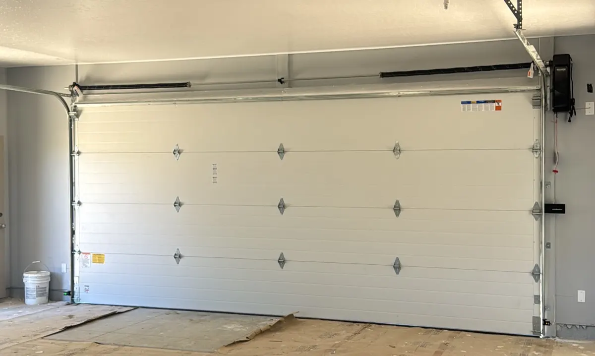 Torsion spring and insulated garage door after spring repair