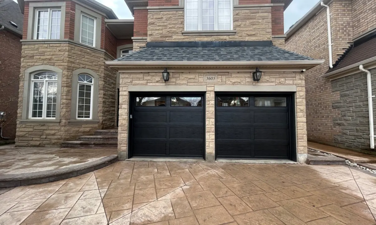 Black two-car residential garage doors repaired on a Costa Mesa home