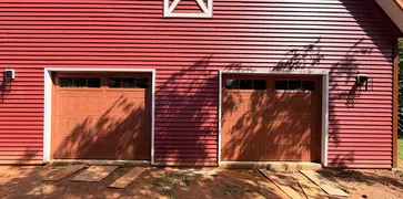 Wood-look garage doors installed on a barn-style garage