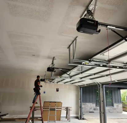 Technician installing a garage door opener