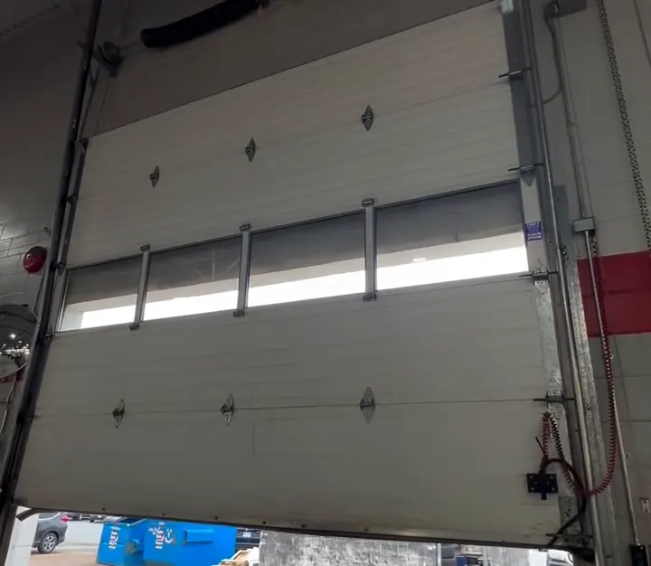 Commercial sectional door with window row