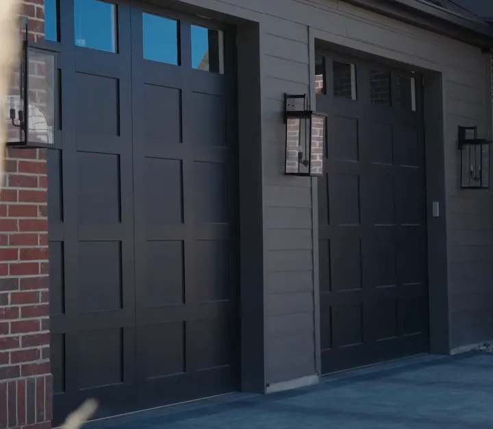 Black carriage-house garage doors on new homes
