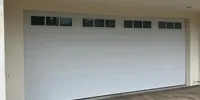 White garage door with window lites over pavers